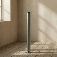 aroma diffuser tower against a textured wall with natural light