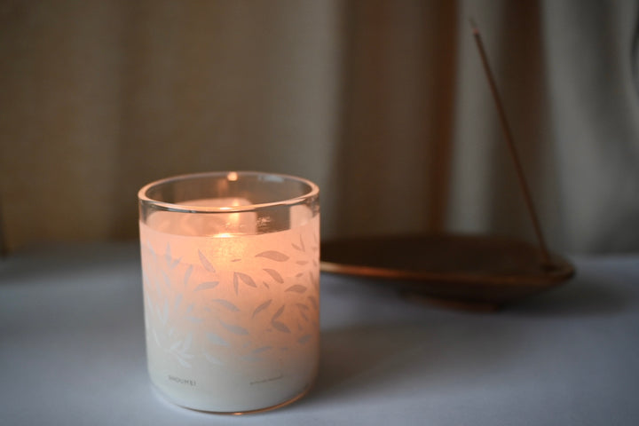 A candle burning at a cozy living room