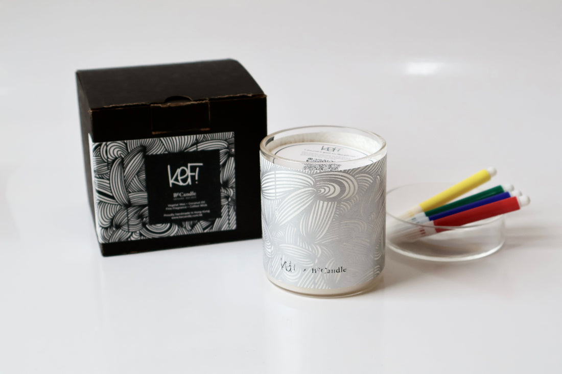 Candle with decorative packaging on a white surface