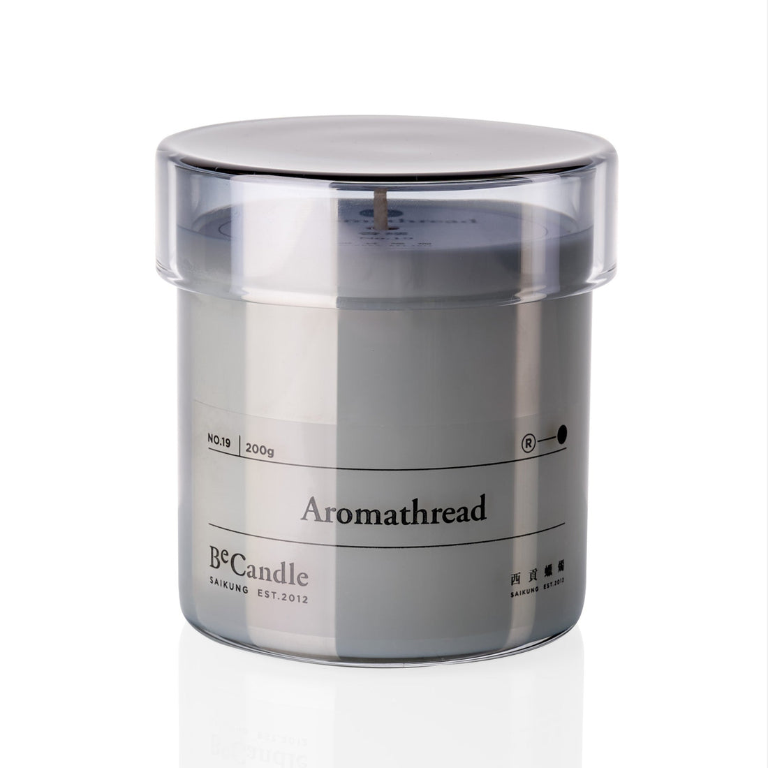 Candle in a clear container with 'Aromathread' branding on a white background