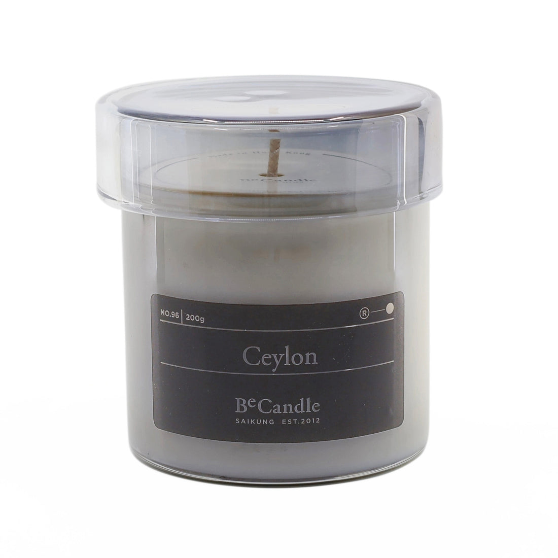 Candle in a clear container with a label on a white background