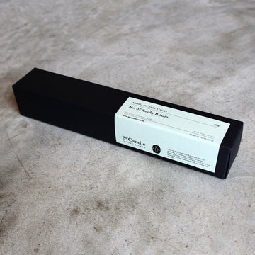Black box with a label on a gray surface