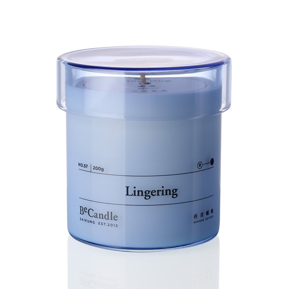 Blue candle in a transparent container labeled 'Lingering' by B&Candle on a white background