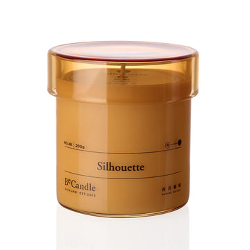 Brown candle container with 'Silhouette' branding on a white background
